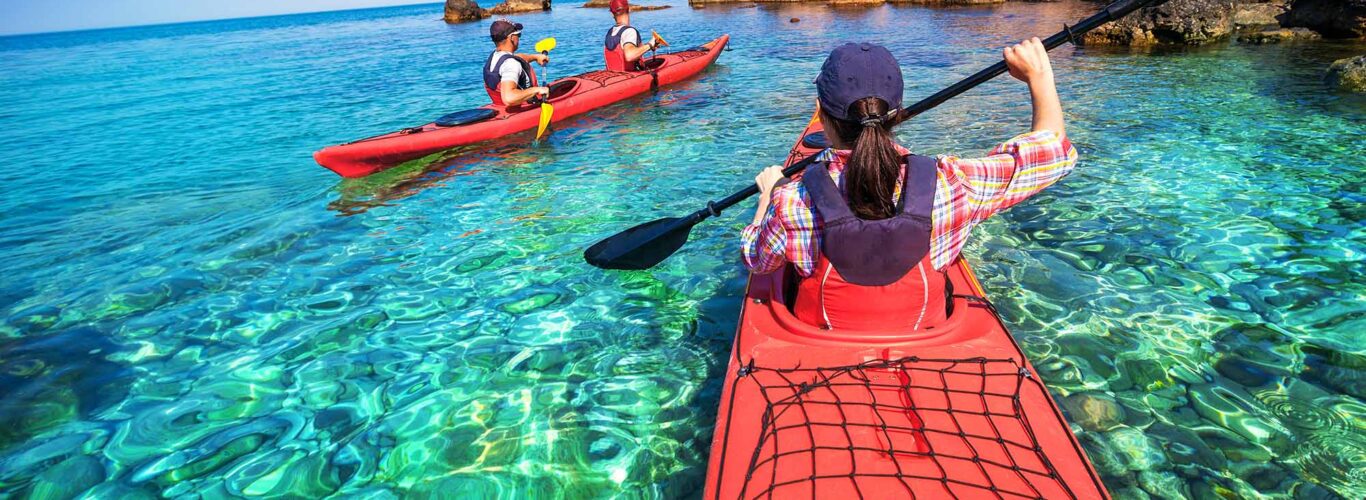 Kayakers using a Joint Jockey while over clear water