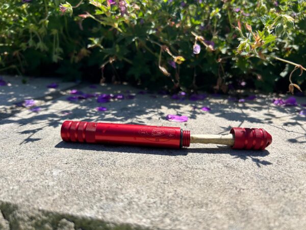 The River Tripper in Rio Red outside under flowers with the top open showing one joint safely stored inside